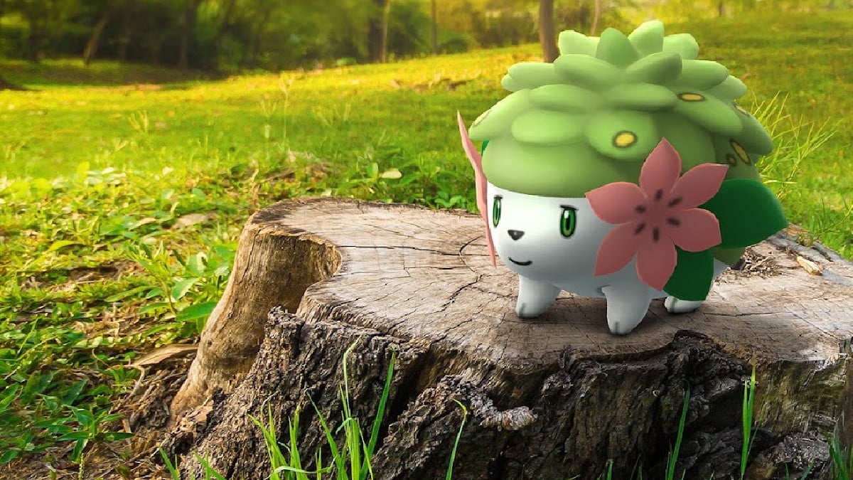 A Shaymin Pokemon sitting on a tree stump