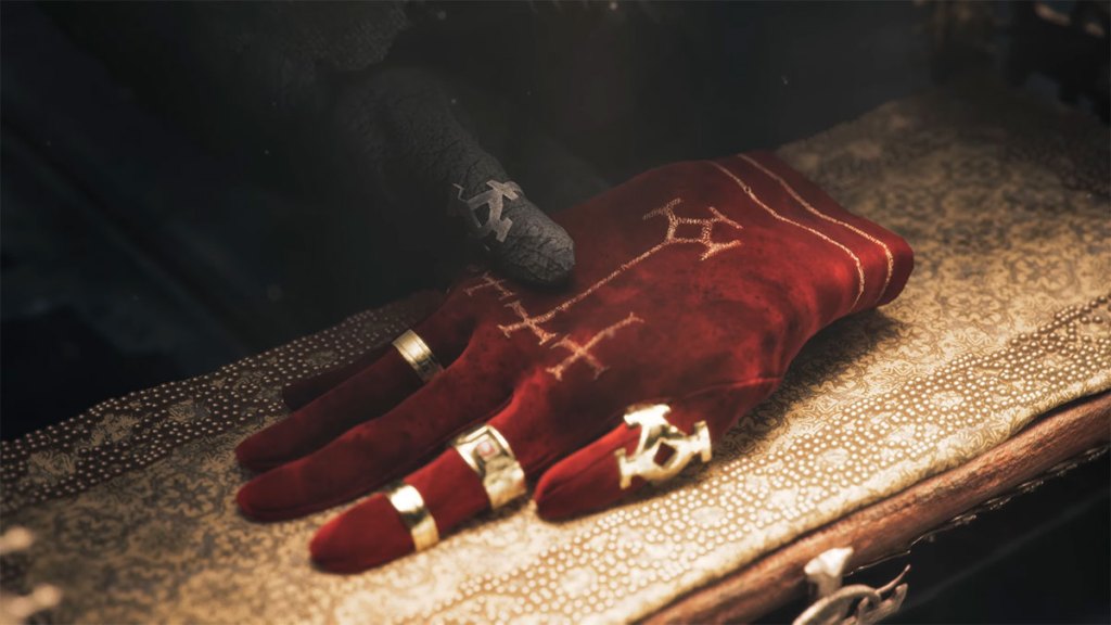 Trailer screenshot from Lords of the Fallen showing a hand grazing a red glove