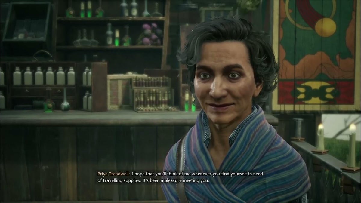 A woman in a late middle age or perhaps early old age with steel grey hair and dark circles around her eyes. She appers to be of South Asian descent. She has a thick knitted stripped shrug on. She stands in front of a well stocked and colorful apothecary. Text in image reads: "Priya Treadwell: I hope that you'll think of me whenever you find yourself in need of traveling supplies. It's been a pleasure meeting you."